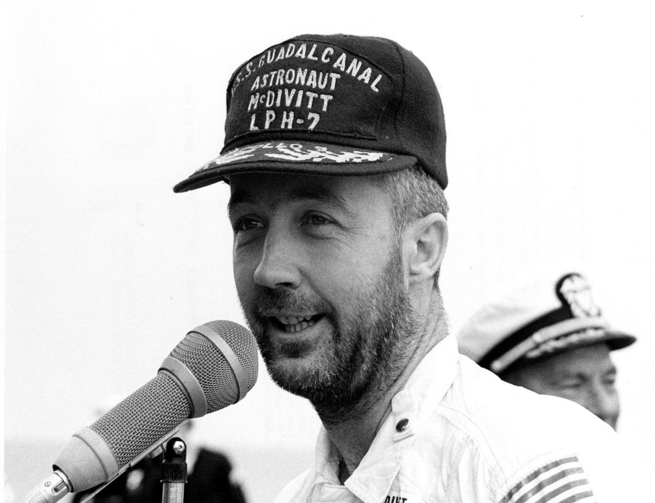 ABOARD THE USS GUADALCANAL -- Bearded Apollo 9 commander James A. McDivitt speaks to personnel aboard the USS Guadalcanal, prime recovery ship, an hour after he and astronauts David R. Scott and Russell L. Schweickart splashed down today in the Atlantic Ocean, 780 nautical miles southeast of Cape Kennedy. Their 10-day Earth orbital flight verified a lunar landing later this year. The National Aeronautics and Space Administration directs the Apollo program.