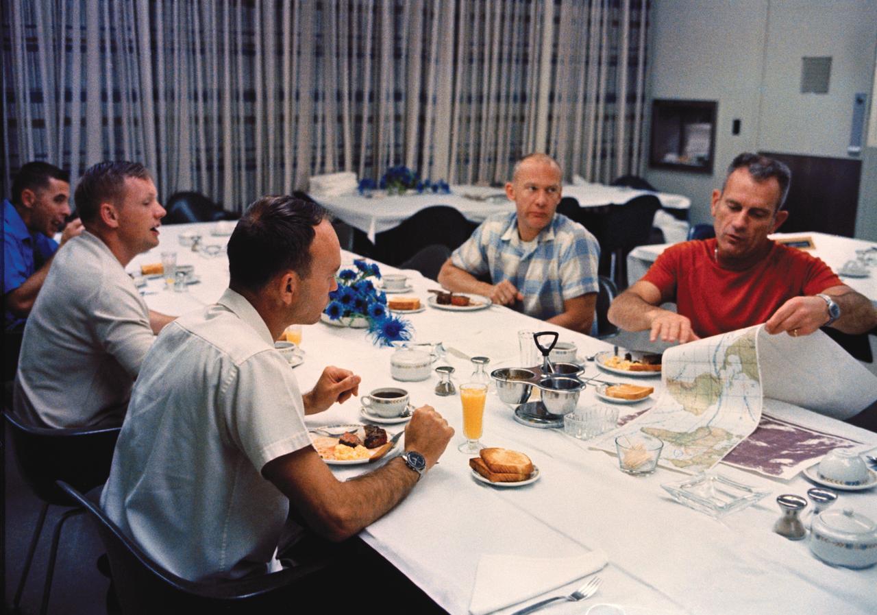 CAPE CANAVERAL, Fla. – Apollo 11 astronauts Neil Armstrong, second from left, Michael Collins and Buzz Aldrin eat breakfast with Donald "Deke" Slayton, in red shirt, on launch day, July 16, 1969. Photo credit: NASA