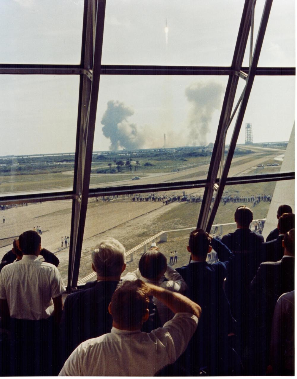 KENNEDY SPACE CENTER, FLA. - Personnel within the Launch Control Center watch the Apollo 11 liftoff from Launch Complex 39A today at the start of the historic lunar landing mission. The LCC is located three-and-one-half miles from the launch pad.