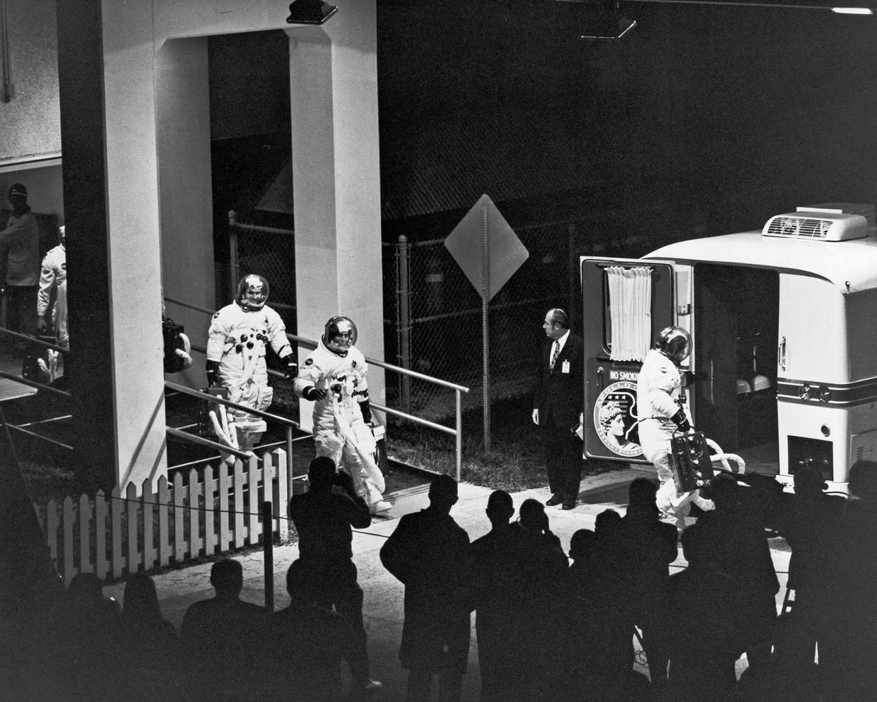 The Apollo 17 prime crew leaves the Manned Spaceflight Operations Building to enter the transfer van which will carry them to Complex 39's Pad A to participate in the CDDT. From right are Eugene A. Cernan, Commander Ronald E. Evans, Command Module Pilot, and Harrison H. Schmitt, Lunar Module Pilot.