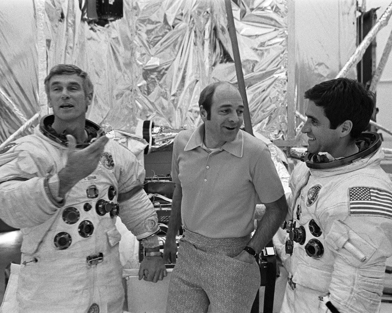 Apollo 17 Mission Commander Eugene A. Cernan, left, jokes with crewmates Ronald E. Evans, center, and Harrison H. Schmitt following training exercises today at the Florida Spaceport. Cernan and Schmitt practiced aspects of their upcoming mission in the full-scale Lunar Module Spacecraft mockup, shown in rear.