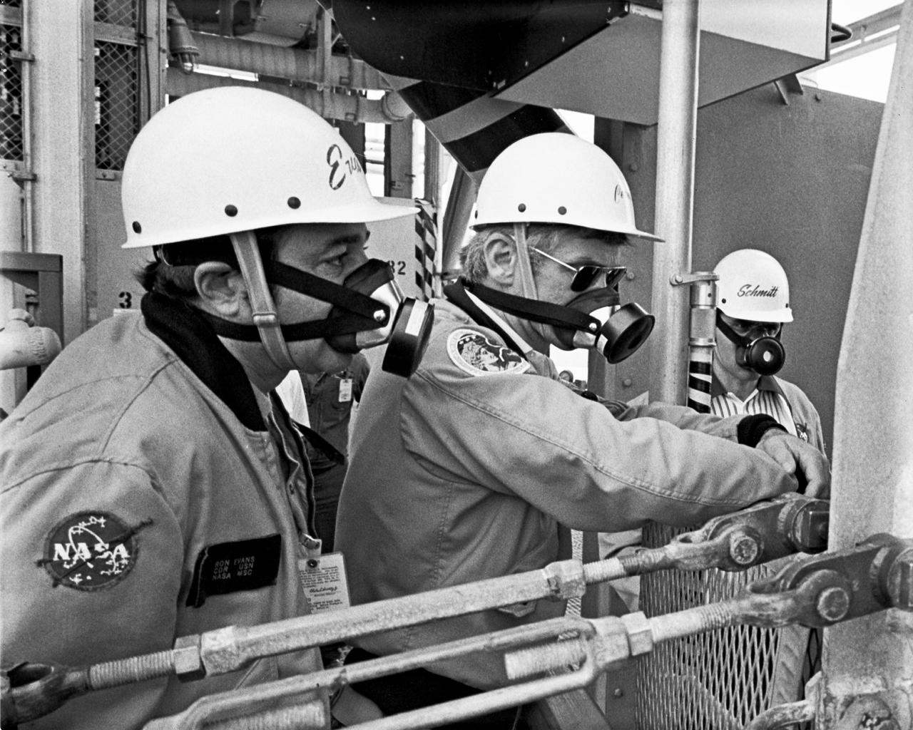Apollo 17 Mission commander, Eugene A. Cernan, in center is flanked by Command Module Pilot Ronald E. Evans and lunar Module Pilot Harrison H. Schmitt as they participate in emergency egress test on the mobile launcher at Complex 39A. They will be launched to the Moon December 6, 1972 on NASA's last manned lunar landing scheduled for this decade.