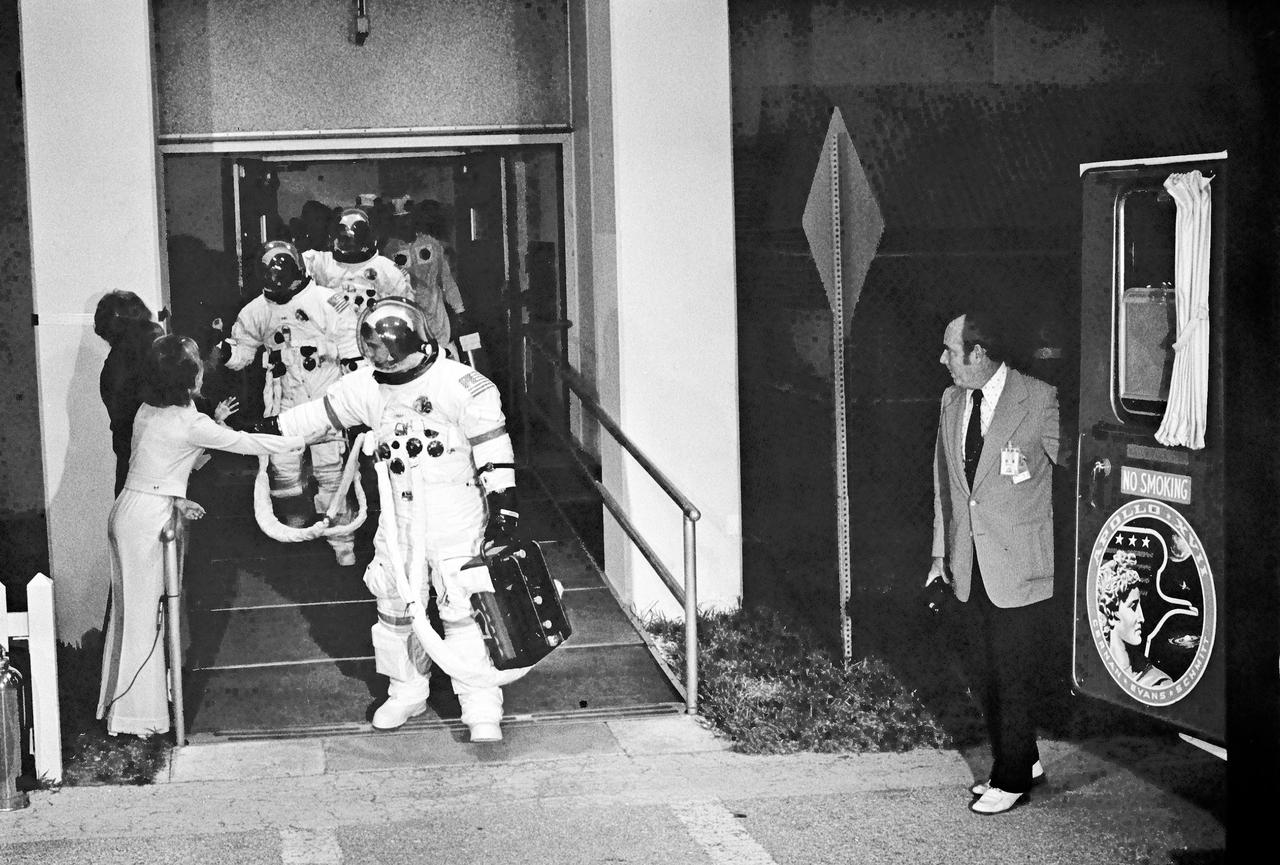 Leaving the Manned Spacecraft Operations Building enroute to the launch pad. Apollo 17 Mission Commander Eugene A.  Cernan greets Mrs. Jan Evans, wife of Command module Pilot Ronald E. Evans, shown in background shaking hand with Cernan's wife Barbara.  Further in the background is lunar Module Pilot Harrison H. Schmitt. At the right, next to the transfer van is Charles Buckley KSC Security Chief.