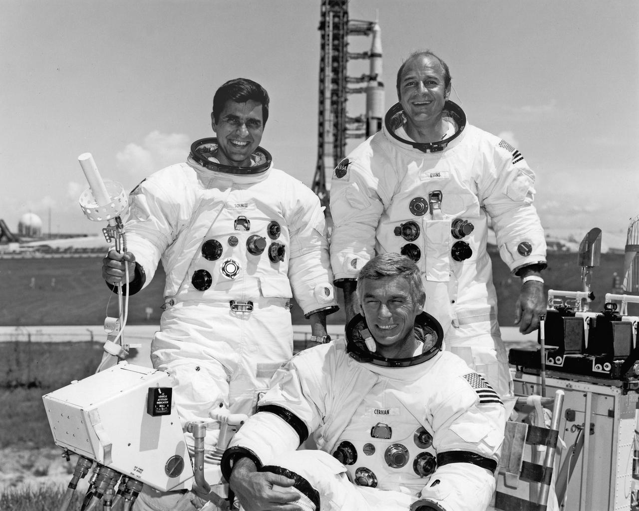 CAPE CANAVERAL, Fla. -- The Apollo 17 crew took time out from training to pose for the press after the Space Vehicle for their Manned Lunar Landing Mission was moved to Pad A, Complex 39 today. Apollo 17 Commander Eugene A Cernan sits at the controls of the One-G Lunar Roving Vehicle Simulator used to simulate operations on the Moon’s surface.  With Cernan are Lunar Module Pilot Dr. Harrison H. “Jack” Schmitt, left and Command Module Plot Ronald A. Evans.  The Apollo 17 Space Vehicle, scheduled for launch from KSC on the sixth U.S. Manned Lunar Landing Mission on December 6, 1972 is in the background.  Photo credit: NASA