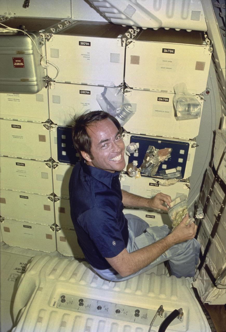 STS-1 ONBOARD PHOTOGRAPHY - STS-1-7-0502:  STS-1 Pilot Robert Crippen at lunch.