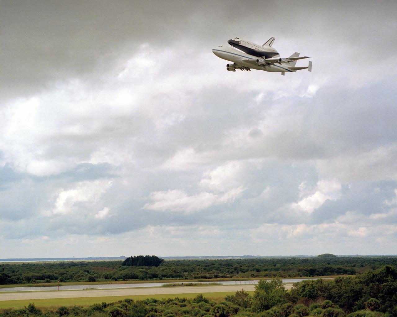 NASA's newest bird, the space shuttle orbiter Discovery, makes a triumphant fly-by of the Space Coast and the Kennedy Space Center runway before landing at 1:46 P.M.