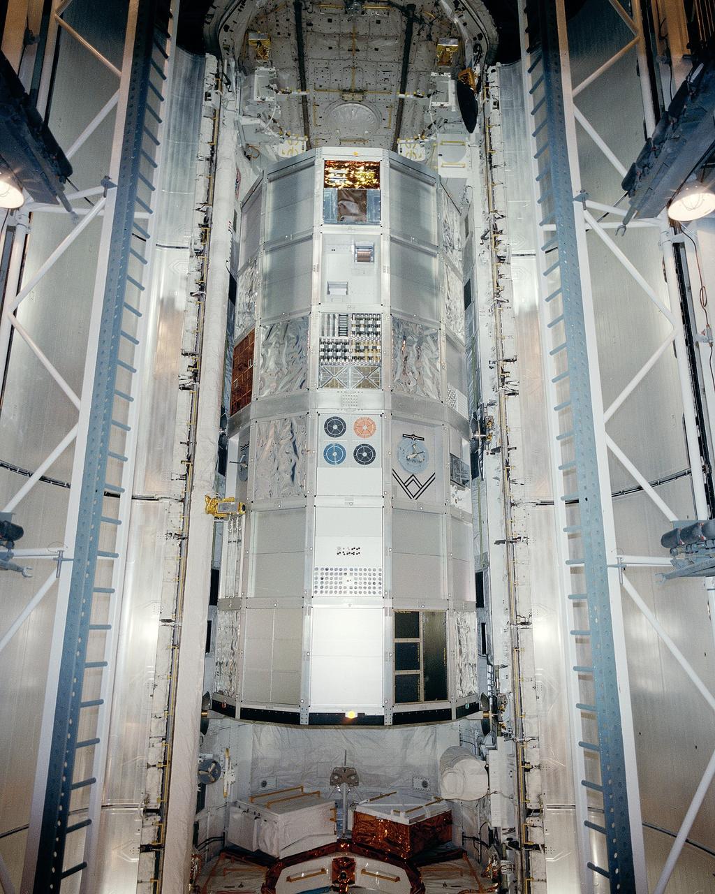 CAPE CANAVERAL, Fla. -- At NASA's Kennedy Space Center's Launch Pad 39-A, the school bus-sized Long Duration Exposure Facility LDEF containing 57 active and passive experiments from nine nations has been loaded into the payload bay of the space shuttle Challenger. The view from the Payload Change-out Room shows LDEF which will be deployed in orbit at an altitude of nearly 300 miles and retrieved after nearly a year so that the experimenters may analyze the effects of long term exposure to space on various substances and processes. The five-member STS-41C crew for this flight is headed by veteran astronaut Robert Crippen on his third space shuttle flight, and includes space rookies, pilot Dick Scobee and mission specialists Terry Hart, George Nelson and James van Hoften. Photo Credit: NASA