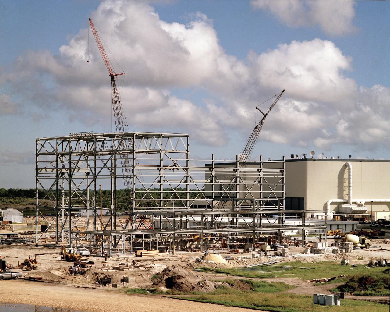 Construction of the Shuttle Orbiter Modification and Refurbishment Facility (OMRF). Northwest of the VAB. 
