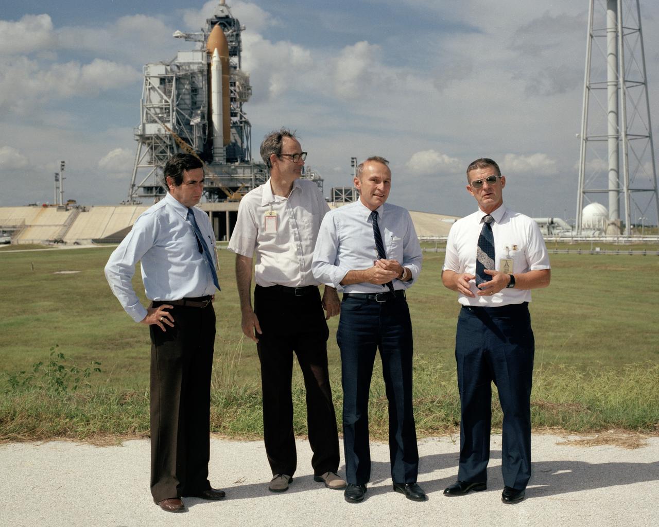 CAPE CANAVERAL, Fla. - Kennedy Space Center Director Lt. Gen. Forrest S. McCartney, far right, stands in front of the space shuttle Atlantis the morning after it is rolled out to Launch Pad 39B. Standing with McCartney is, from right to left, Bob Sieck, director of Shuttle Management and Operations, Bill Warren, pad site manager, and Gene Thomas, director of Launch and Landing Operations.    Photo credit: NASA