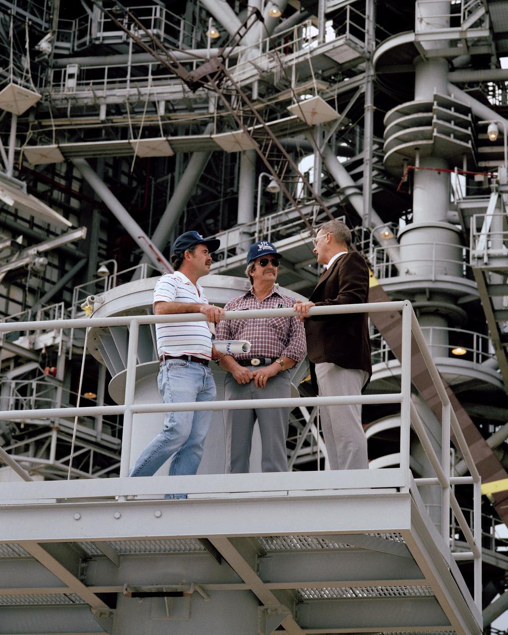 CAPE CANAVERAL, Fla. - Kennedy Space Center Director Forrest McCartney, right, discusses work in progress at Launch Pad 39B as preparations for STS-26 continue. From left are Gary Wall, Lockheed mechanical technician, Joe  Spivey, Lockheed hypergolic technician, and McCartney.      Photo credit: NASA