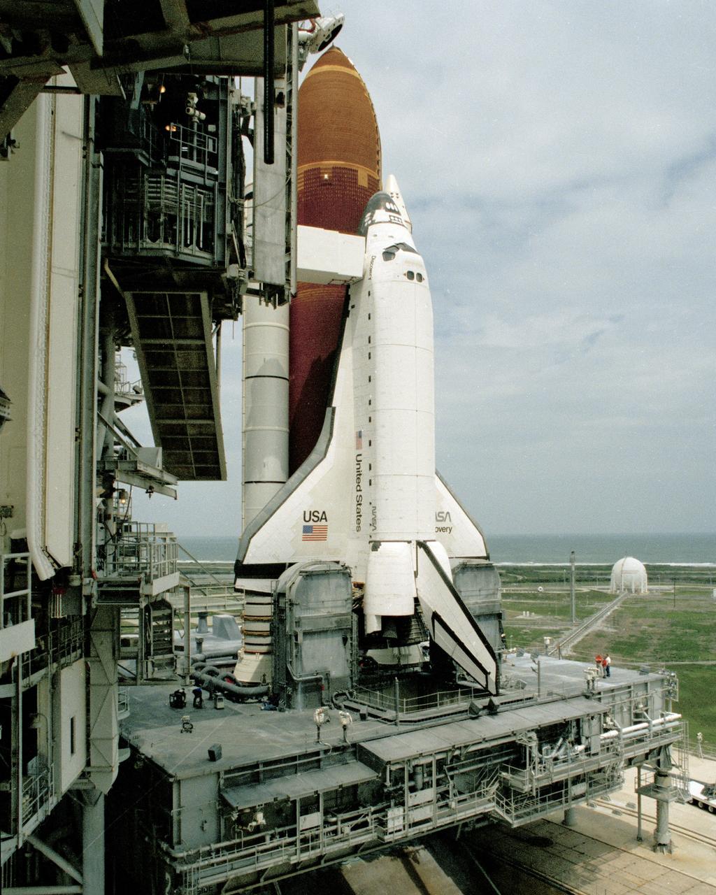 The orbiter Discovery is unveiled as rollback of the Rotating Service Structure begins during final prelaunch preparations at Launch Pad 39B on April 9.  Space shuttle mission STS-31, carrying a crew of five and the Hubble Space Telescope, is set to lift off at 6:47 a.m. EDT, April 10.  Photo credit: NASA