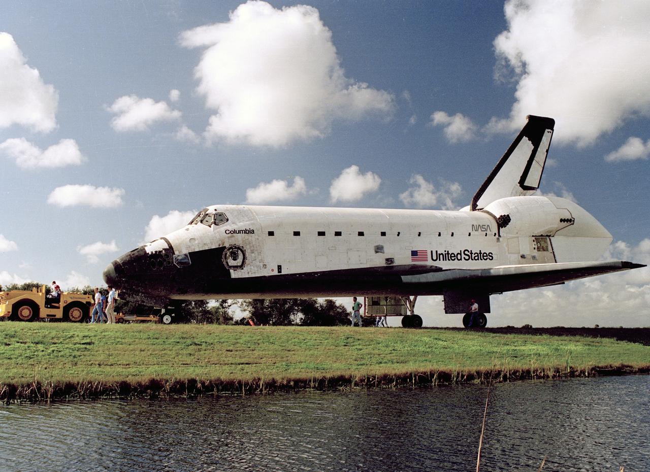 CAPE CANAVERAL, Fla. – The orbiter Columbia heads for the Vehicle Assembly Building following its arrival at the Shuttle Landing Facility.  OV-102's return brings full circle mission STS-35, a nine-day flight to study astrophysics.    Photo credit: NASA