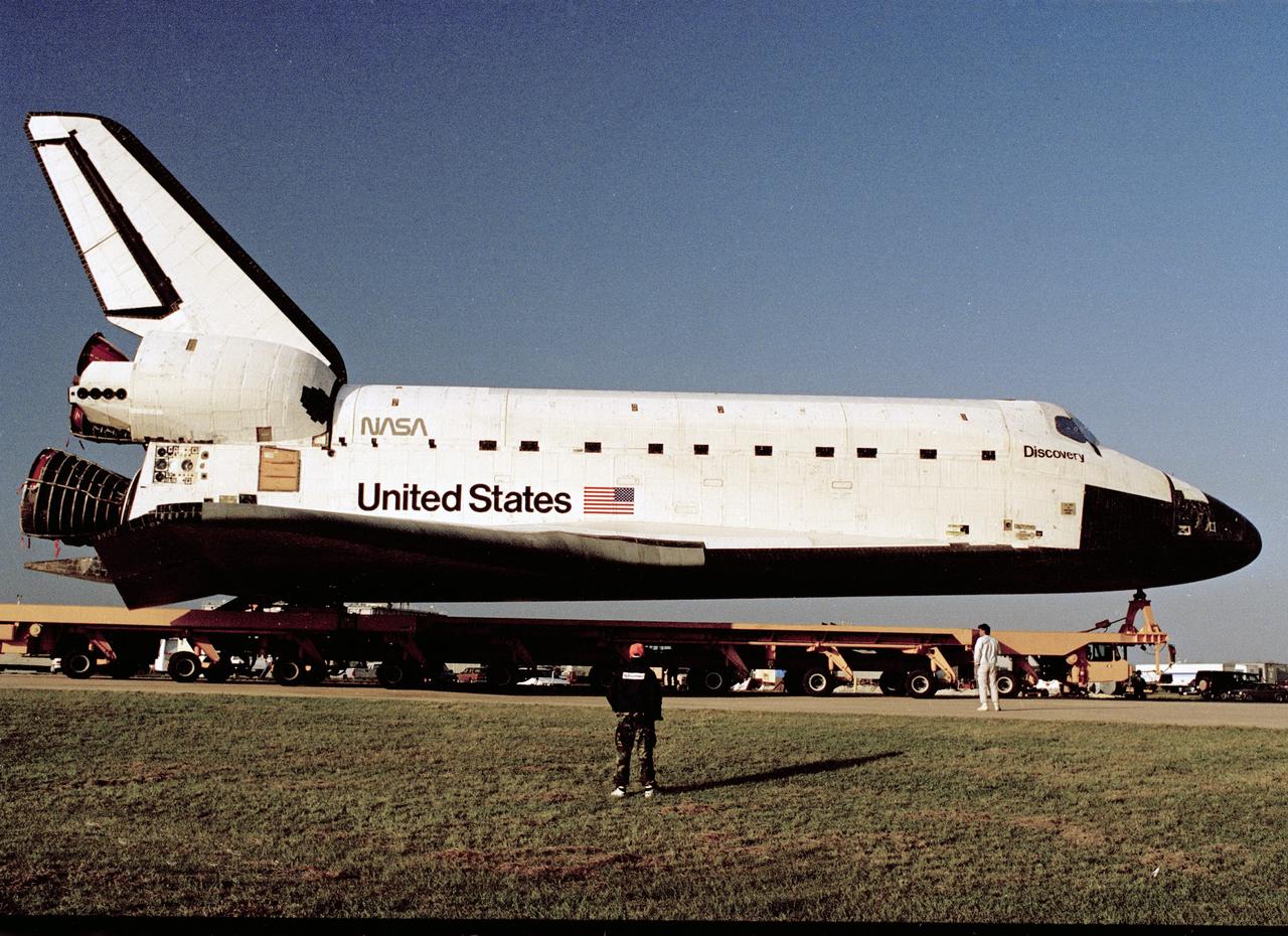CAPE CANAVERAL, Fla. – The orbiter Discovery, its wheels retracted atop the orbiter transporter, rolls over from the OPF high bay to the VAB. Discovery is slated to lift off in March on mission STS-39, a DoD flight carrying a crew of seven.    Photo credit: NASA