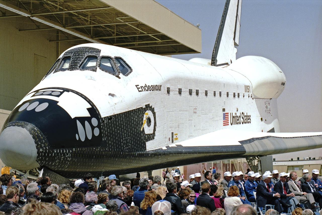 The newest space shuttle orbiter, Endeavour, rolls out of the hangar at Palmdale, Calif. OV-105 features many design enhancements, including a drag chute for safer landings and equipment to allow the orbiter to remain in space for up to 28 days. Photo credit: NASA