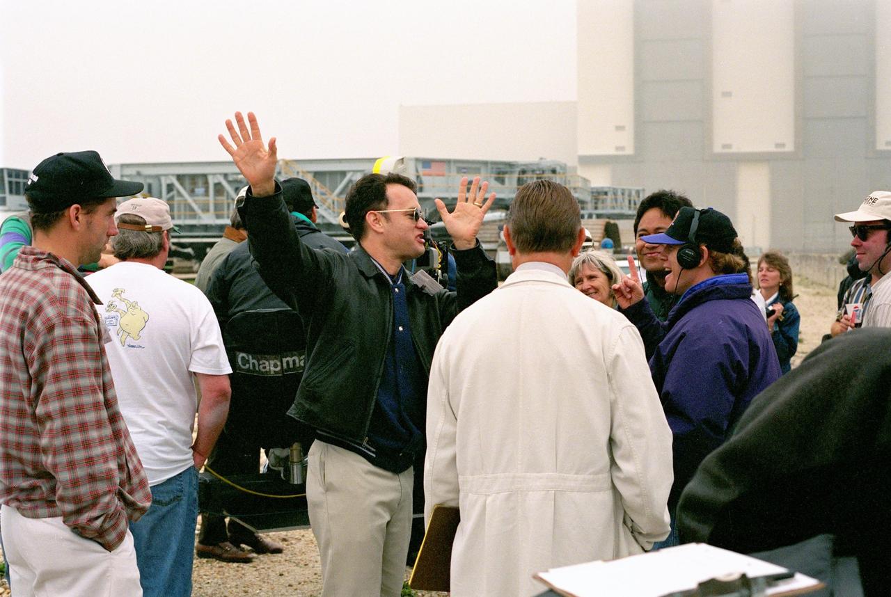 KENNEDY SPACE CENTER, FLA. --  Film director Ron Howard [right, with head phones] and a production crew, along with actor Tom Hanks [center], are filming a number of scenes at KSC for an upcoming film about the Apollo 13 mission.                          