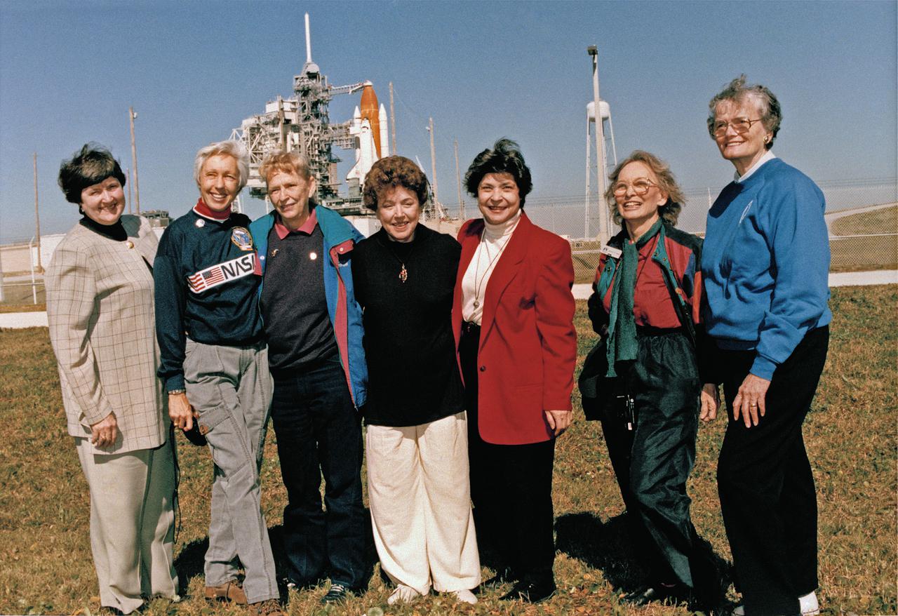 CAPE CANAVERAL, Fla. -- Exuberant and thrilled to be at Kennedy Space Center, seven women who once aspired to fly into space stand outside Launch Pad 39B near the space shuttle Discovery, poised for liftoff on the first flight of 1995.  Visiting the space center as invited guests of STS-63 Pilot Eileen Collins are from left Gene Nora Jessen, Wally Funk, Jerrie Cobb, Jerri Truhill, Sarah Rutley, Myrtle Cagle and Bernice Steadman.  They are members of the Mercury 13 group of women who trained to become astronauts for America's first human spaceflight program back in the early 1960s.  Although the Mercury 13 effort was eventually cancelled, the women are proud to know that their commitment helped pave the way for the milestone Collins will soon set: becoming the first female shuttle pilot. Photo credit: NASA