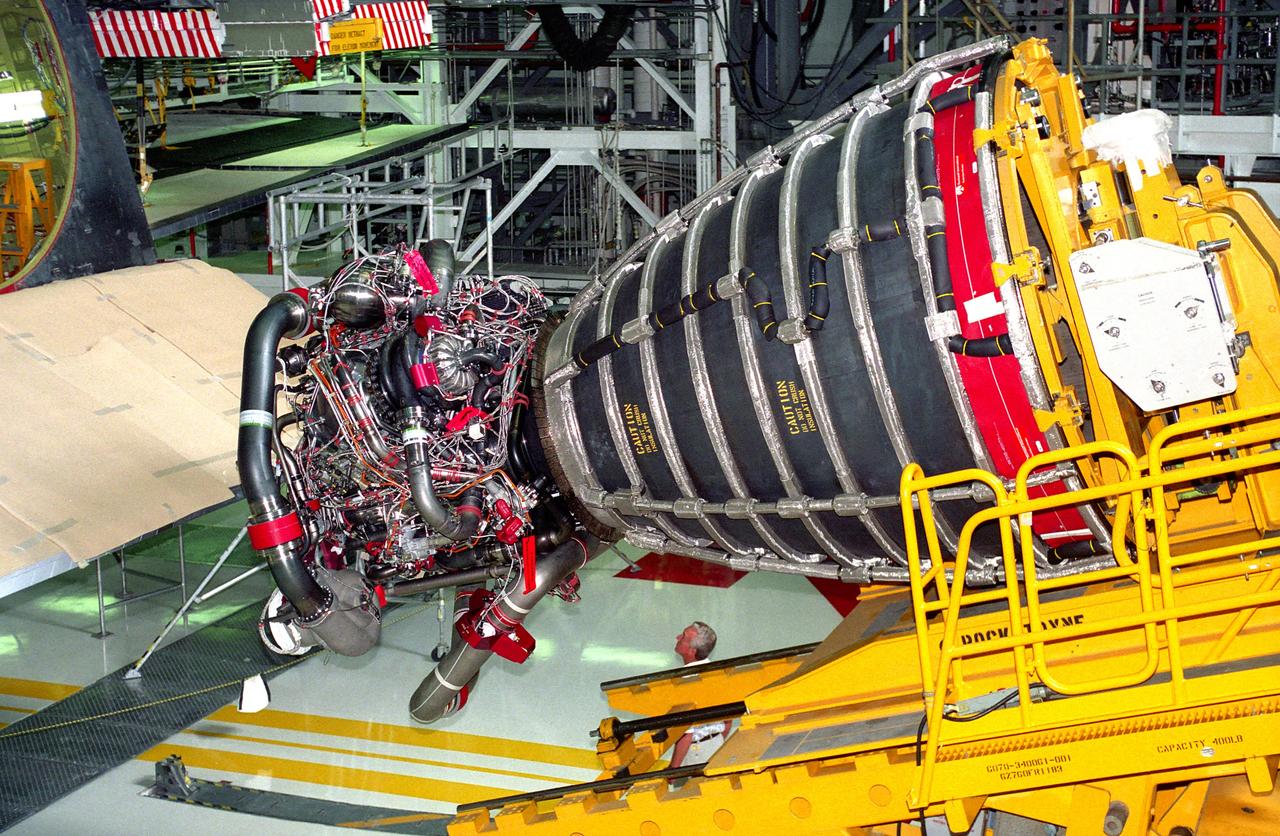 KENNEDY SPACE CENTER, FLA. -  Space Shuttle Main Engine (SSME) No. 2036, the first of the new Block 1 engines to fly,  awaits installation into position one of the orbiter Discovery in Orbiter Processing Facility 2 during preparation of the spaceplane for the STS-70 mission.  The advanced powerplant features a new high-pressure liquid oxygen turbopump, a two-duct powerhead, a baffleless main injector, a single-coil heat exchanger and start sequence modifications.  These modifications are designed to improve both engine performance and safety.