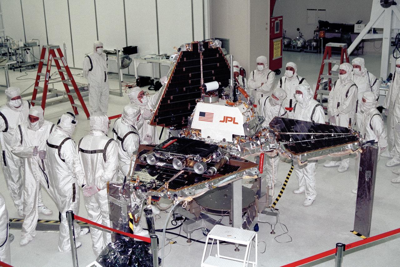 CAPE CANAVERAL, Fla. -- In the Spacecraft Assembly and Encapsulation Facility-2 at NASA's Kennedy Space Center in Florida, Jet Propulsion Laboratory technicians are closing up the metal "petals" of the Mars Pathfinder lander. The Sojourner rover is visible on one of the three petals. Photo Credit: NASA