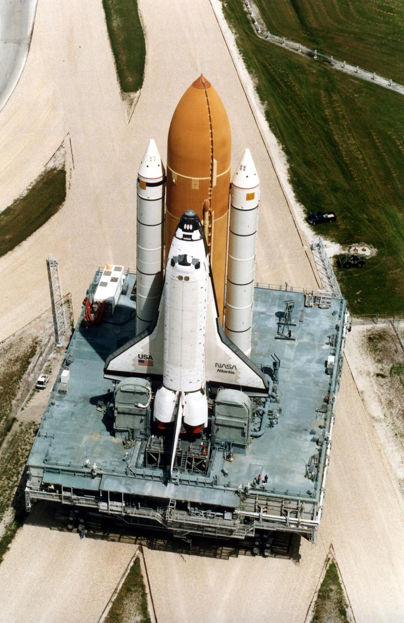 KENNEDY SPACE CENTER, FLA. -- Atlantis, with its new external tank/solid rocket booster stack, rolls out to Pad 39A on August 20, 1996, in preparation for launch of STS-79 on the fourth Mir docking mission. Atlantis will return Astronaut Shannon Lucid to Earth after her record-breaking stay by an American on the Russian space  station. Lucid has completed 21 weeks in space this week. Astronaut John Blaha will trade places with Lucid for a planned four-month stay aboard Mir. Atlantis will also carry the first SPACEHAB Double Module.