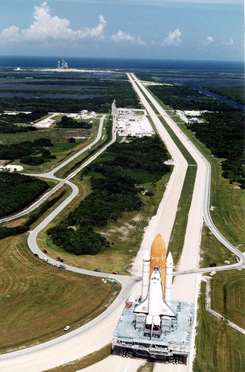 KENNEDY SPACE CENTER, FLA. -- Atlantis, with its new external tank/solid rocket booster stack, rolls out to Pad 39A on August 20, 1996, in preparation for launch of STS-79 on the fourth Mir docking mission. Atlantis will return Astronaut Shannon Lucid to Earth after her record-breaking stay by an American on the Russian space  station. Lucid has completed 21 weeks in space this week. Astronaut John Blaha will trade places with Lucid for a planned four-month stay aboard Mir. Atlantis will also carry the first SPACEHAB Double Module