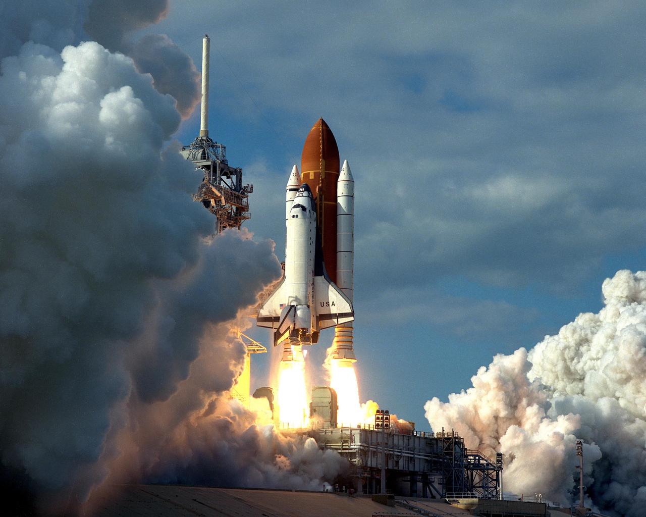 KENNEDY SPACE CENTER, FLA. -- A diversified mission of astronomy, commercial space research and International Space Station preparation gets under way as the Space Shuttle Columbia climbs into orbit from Launch Pad 39B at 2:55:47 p.m. EST, Nov. 19, 1996. During Mission STS- 80, Columbia’s five-person crew will deploy and retrieve two free-flying spacecraft, conduct two spacewalks and perform a variety of microgravity research experiments in the Shuttle’s middeck area. The veteran crew is led by Commander Kenneth D. Cockrell; Kent V. Rominger is the pilot and the three mission specialists are Tamara E. Jernigan, Story Musgrave and Thomas D. Jones. At age 61, Musgrave becomes the oldest person ever to fly in space; he also ties astronaut John Young’s record for most number of spaceflights by a human being, and in embarking on his sixth Shuttle flight Musgrave has logged the most flights ever aboard NASA’s reusable space vehicle. The two primary payloads for STS-80 are the Wake Shield Facility-3 (WSF-3) and the Orbiting and Retrievable Far and Extreme Ultraviolet Spectrometer-Shuttle Pallet Satellite II (ORFEUS-SPAS II).