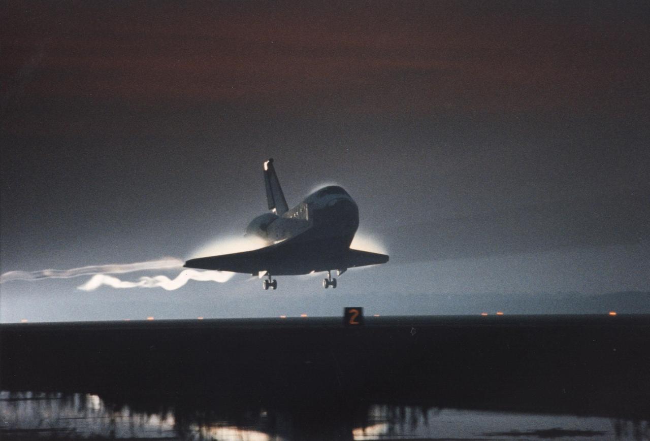 KENNEDY SPACE CENTER, FLA. -- With sunrise just minutes away, the orbiter Columbia swoops down on KSC’s Shuttle Landing Facility, Runway 33. The 33rd KSC landing in Shuttle program history is set to occur on the first opportunity Dec. 7 at 6:49 a.m. EST. Prior landing attempts Dec. 5 and 6 were scrubbed due to weather conditions. The extended time aloft allowed the five- member crew of Mission STS-80 to set a new record for long-duration Shuttle flight. At main gear touchdown, mission duration will be about 17 days, 16 hours, surpassing the 16-day, 21-hour set by the STS-78 crew earlier this year. Guiding Columbia onto the runway is STS-80 Commander Kenneth D. Cockrell; the pilot is Kent V. Rominger. The three mission specialists are Tamara E. Jernigan, Thomas D. Jones and Story Musgrave.   
