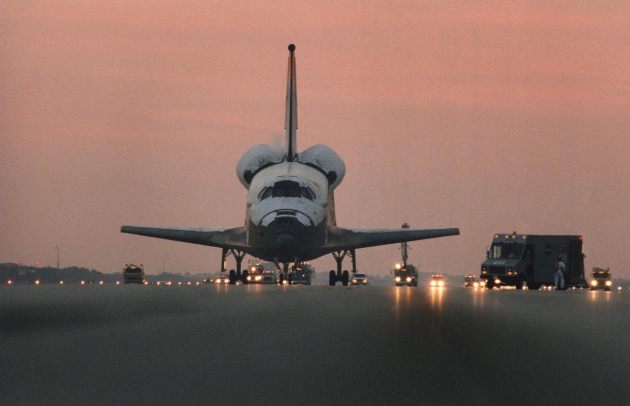 KENNEDY SPACE CENTER, FLA. -- Recovery convoy equipment greets the orbiter Columbia following main gear touchdown at 6:49:05 a.m. EST, Dec. 7, on Runway 33 of KSC’s Shuttle Landing Facility. The return to Earth of NASA’s oldest spaceplane occurred just moments before sunrise. This was the 33rd landing at KSC in Shuttle program history.