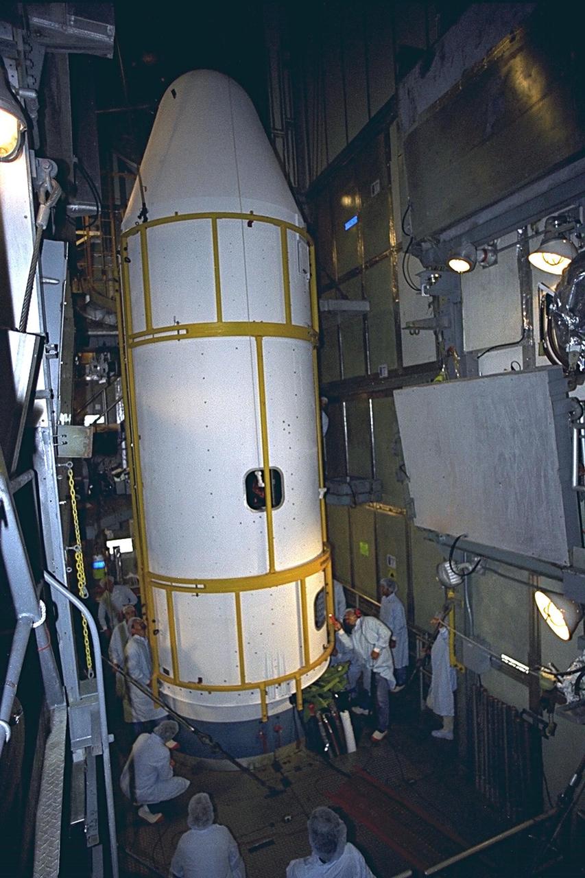 Workers make final checks as the second part of the bi-sector payload fairing for the Advanced Composition Explorer (ACE) is closed around the spacecraft at Launch Complex 17A, Cape Canaveral Air Station. ACE will be launched on a Boeing Delta II expendable launch vehicle. The spacecraft will investigate the origin and evolution of solar phenomenon, the formation of solar corona, solar flares and acceleration of the solar wind. This will be the second Delta launch under the Boeing name and the first from Cape Canaveral. Liftoff is scheduled Aug. 24