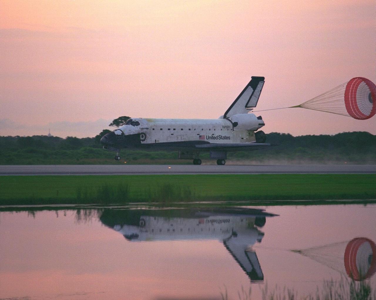 KENNEDY SPACE CENTER, FLA. -- With its drag chute deployed, the Space Shuttle  Orbiter Columbia touches down on Runway 33 at KSC’s Shuttle Landing Facility at  6:46:34 a.m. EDT  with Mission Commander  James D. Halsell Jr. and Pilot Susan L.  Still at the controls to complete the STS-94 mission. Also on board are Mission Specialist  Donald A. Thomas, Mission Specialist Michael L. Gernhardt , Payload Commander  Janice Voss, and Payload Specialists Roger  K.  Crouch and Gregory T. Linteris. Mission  elapsed time for STS-94 was 15 days,16 hours, 44 seconds. During the Microgravity  Science Laboratory-1 (MSL-1) mission, the Spacelab module was used to test some of the  hardware, facilities and procedures that are planned for use on the International Space  Station while the flight crew conducted combustion, protein crystal growth and materials  processing experiments. This mission was a reflight of  the STS-83 mission that lifted off   from KSC in April of this year. That space flight was cut short due to indications of a  faulty fuel cell. This was Columbia’s 11th landing at KSC and the 38th landing at the  space center in the history of the Shuttle program