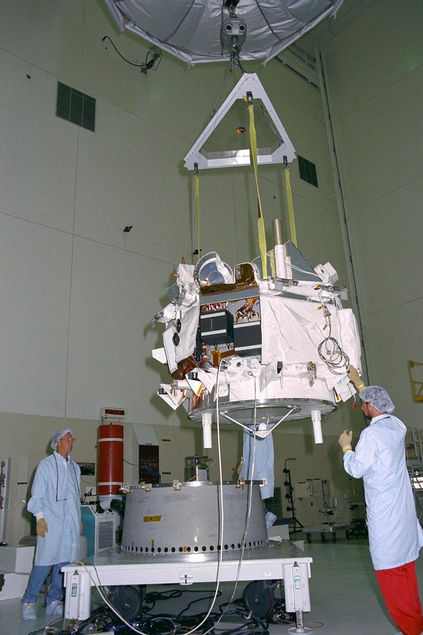 Applied Physics Laboratory engineers and technicians from Johns Hopkins University assist in guiding the Advanced Composition Explorer (ACE) as it is hoisted over a platform for solar array installation in KSC’s Spacecraft Assembly and Encapsulation Facility-II. Scheduled for launch on a Delta II rocket from Cape Canaveral Air Station on Aug. 25, ACE will study low-energy particles of solar origin and high-energy galactic particles. The ACE observatory will contribute to the understanding of the formation and evolution of the solar system as well as the astrophysical processes involved. The collecting power of instruments aboard ACE is 10 to 1,000 times greater than anything previously flown to collect similar data by NASA