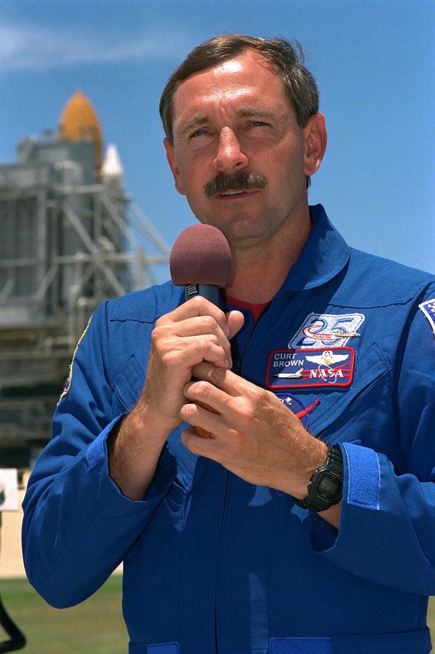 KENNEDY SPACE CENTER, Fla. -- STS-85 Commander Curtis L. Brown, Jr.,  addresses the news media at a briefing at Launch Pad 39A during a break in Terminal  Countdown Demonstration Test (TCDT) activities for that mission. The primary payload  aboard the Space Shuttle orbiter Discovery is the Cryogenic Infrared Spectrometers and  Telescopes for the Atmosphere-2 (CRISTA-SPAS-2).  Other payloads on the 11-day  mission include the Manipulator Flight Demonstration (MFD),  and Technology  Applications and Science-1 (TAS-1) and International Extreme Ultraviolet Hitchhiker-2  (IEH-2) experiments
