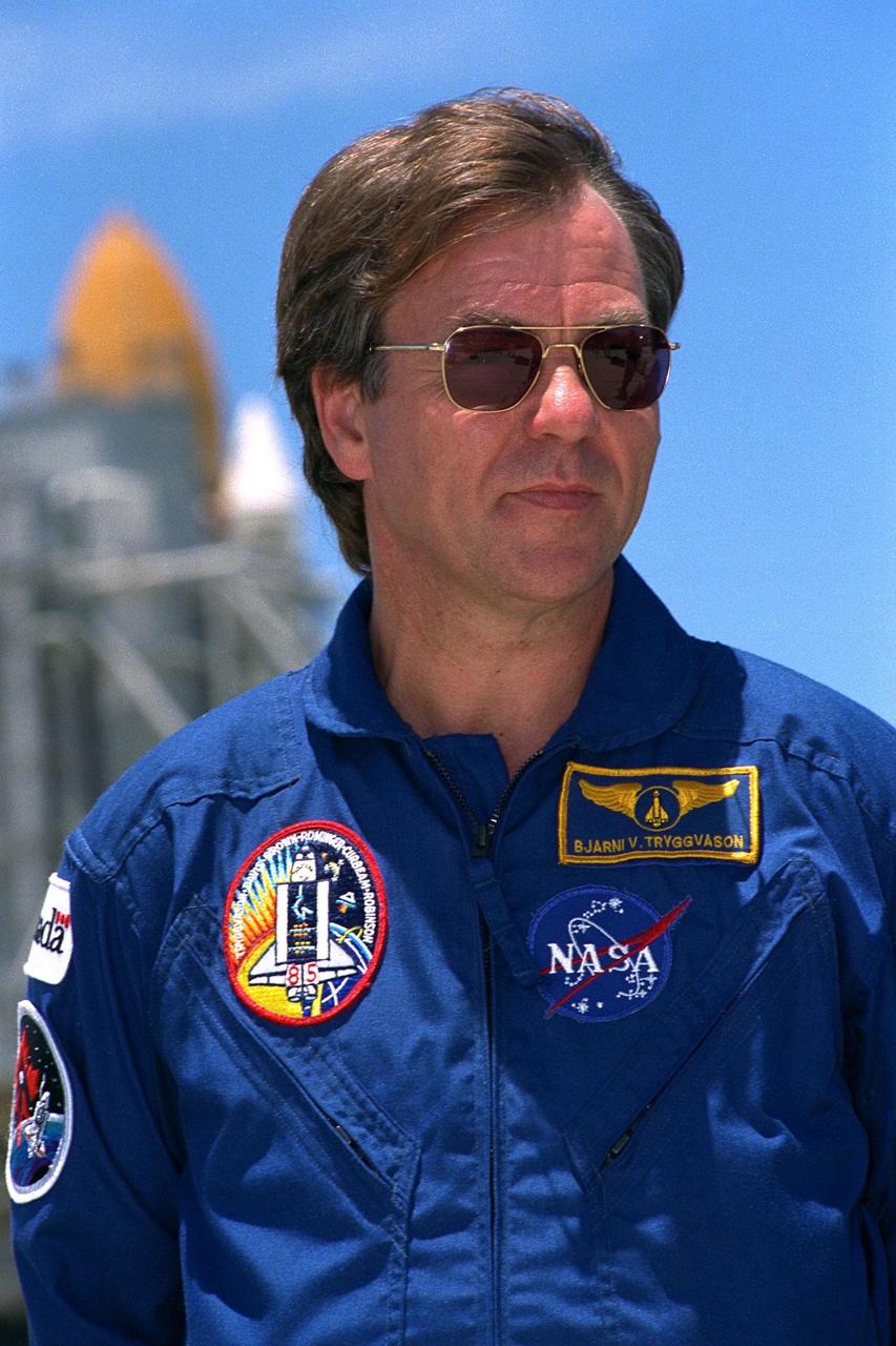 KENNEDY SPACE CENTER, Fla. -- STS-85 Payload Specialist Bjarni V. Tryggvason  stands ready for questions at a news briefing at Launch Pad 39A during a break in  Terminal Countdown Demonstration Test (TCDT) activities for that mission. The  primary payload aboard the Space Shuttle orbiter Discovery is the Cryogenic Infrared  Spectrometers and Telescopes for the Atmosphere-2 (CRISTA-SPAS-2). Other payloads  on the 11-day mission include the Manipulator Flight Demonstration (MFD),  and  Technology Applications and Science-1 (TAS-1) and International Extreme Ultraviolet  Hitchhiker-2 (IEH-2) experiments