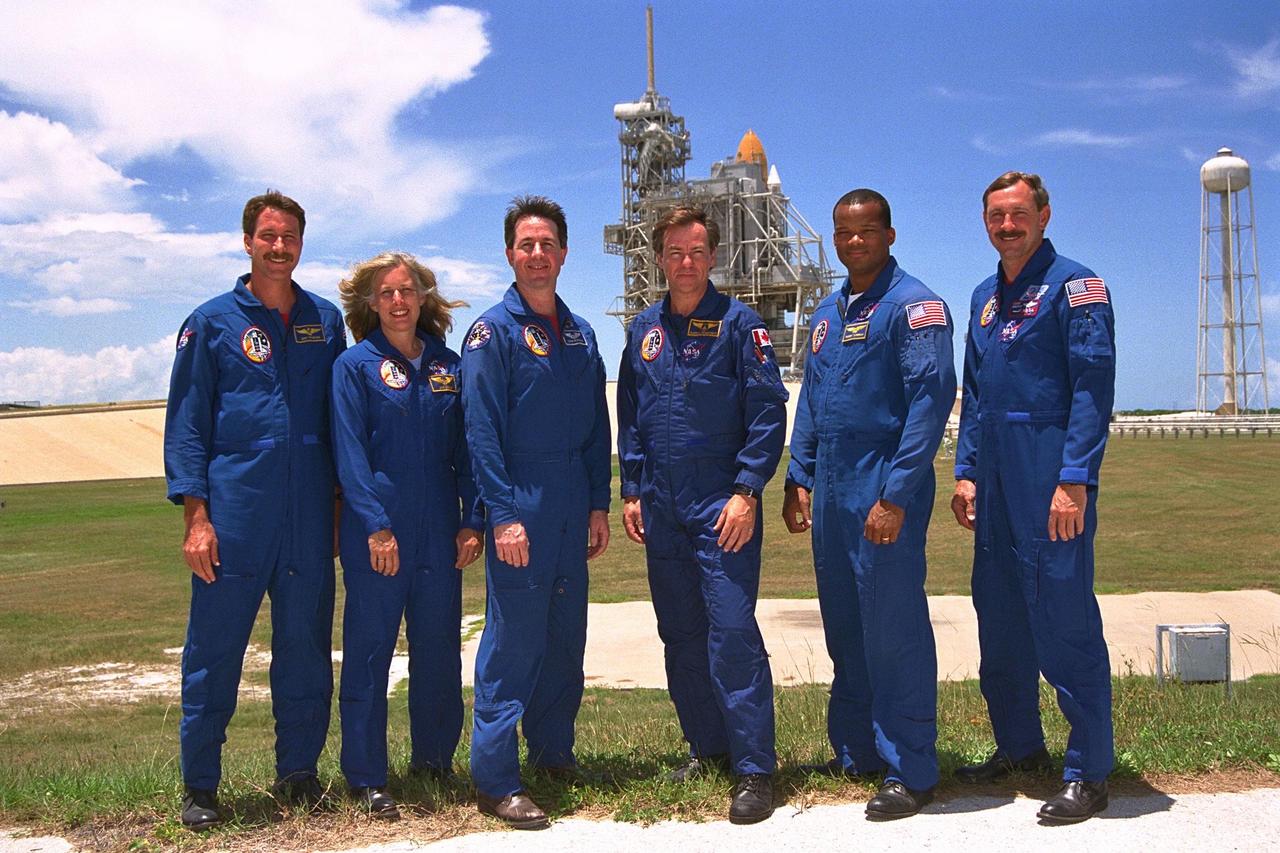 KENNEDY SPACE CENTER, Fla. -- The STS-85 flight crew poses at Launch Pad 39A  during a break in Terminal Countdown Demonstration Test (TCDT) activities for that  mission. They are (back row, from left):  Pilot Kent V. Rominger; Payload Commander  N. Jan Davis; Mission Specialist Stephen K. Robinson; Payload Specialist Bjarni V.  Tryggvason; Mission Specialist Robert L. Curbeam, Jr.; and Commander Curtis L.  Brown, Jr.  The primary payload aboard the Space Shuttle orbiter Discovery is the  Cryogenic Infrared Spectrometers and Telescopes for the Atmosphere-2 (CRISTA-SPAS-2). Other payloads on the 11-day mission include the Manipulator Flight Demonstration  (MFD), and Technology Applications and Science-1 (TAS-1) and International Extreme  Ultraviolet Hitchhiker-2 (IEH-2) experiments