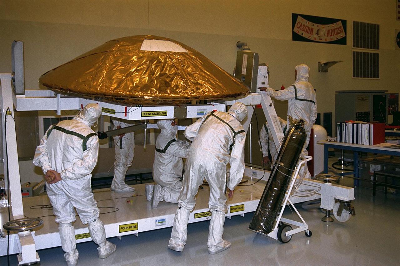 The Huygens probe is installed into the Cassini orbiter in the Payload Hazardous Servicing Facility (PHSF)