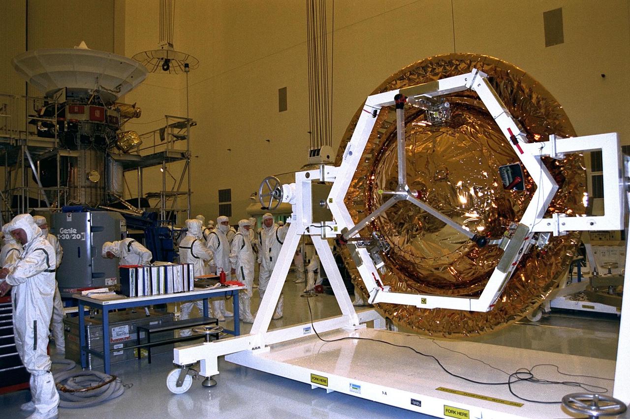 The Huygens probe is installed into the Cassini orbiter in the Payload Hazardous Servicing Facility (PHSF)