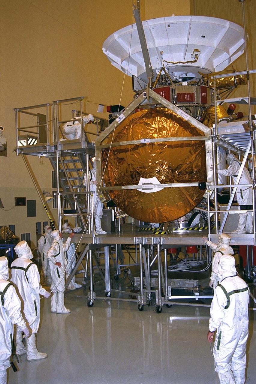 The Huygens probe is installed into the Cassini orbiter in the Payload Hazardous Servicing Facility (PHSF)