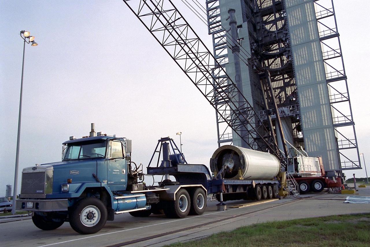 The second stage of the Lockheed Martin Launch Vehicle-2 (LMLV-2) arrives aboard a truck at Launch Complex 46 at Cape Canaveral Air Station before it is mated to the first stage, seen in the center of the pad structure in the background. The LMLV-2 will carry the Lunar Prospector spacecraft, scheduled to launch in October for an 18-month mission that will orbit the Earth’s moon to collect data from the lunar surface. Scientific experiments to be conducted by the Prospector include locating water ice that may exist near the lunar poles, gathering data to understand the evolution of the lunar highland crust and the lunar magnetic field, finding radon outgassing events, and describing the lunar gravity field by means of Doppler tracking