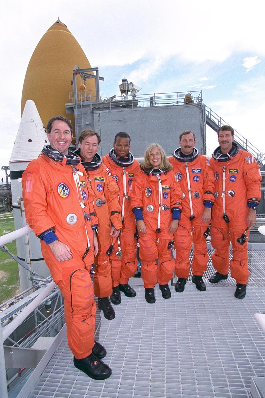 KENNEDY SPACE CENTER, Fla. -- The STS-85 flight crew members pose at the  195-foot level of Launch Pad 39A with the Space Shuttle Discovery in the background  during Terminal Countdown Demonstration Test (TCDT) activities for that mission.  They are (from left): Mission Specialist Stephen K. Robinson; Payload Specialist  Bjarni V. Tryggvason; Mission Specialist Robert L. Curbeam, Jr.; Payload Commander  N. Jan Davis; Commander Curtis L. Brown, Jr.; and Pilot Kent V. Rominger. The  primary payload aboard the Space Shuttle orbiter Discovery is the Cryogenic Infrared  Spectrometers and Telescopes for the Atmosphere-2 (CRISTA-SPAS-2). Other STS-85  payloads include the Manipulator Flight Demonstration (MFD),  and Technology  Applications and Science-1 (TAS-1) and International Extreme Ultraviolet Hitchhiker-2  (IEH-2) experiments