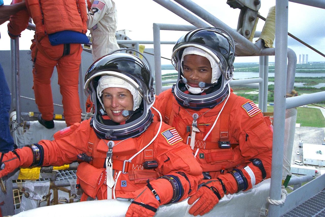 KENNEDY SPACE CENTER, Fla. -- STS-85 Payload Commander N. Jan Davis (left)  and Mission Specialist Robert L. Curbeam, Jr., check out an emergency egress slidewire  basket at the 195-foot level of Launch Pad 39A during Terminal Countdown  Demonstration Test (TCDT) activities for that mission. The primary payload aboard the  Space Shuttle orbiter Discovery is the Cryogenic Infrared Spectrometers and Telescopes  for the Atmosphere-2 (CRISTA-SPAS-2). Other STS-85 payloads include the  Manipulator Flight Demonstration (MFD), and Technology Applications and Science-1  (TAS-1) and International Extreme Ultraviolet Hitchhiker-2 (IEH-2)
