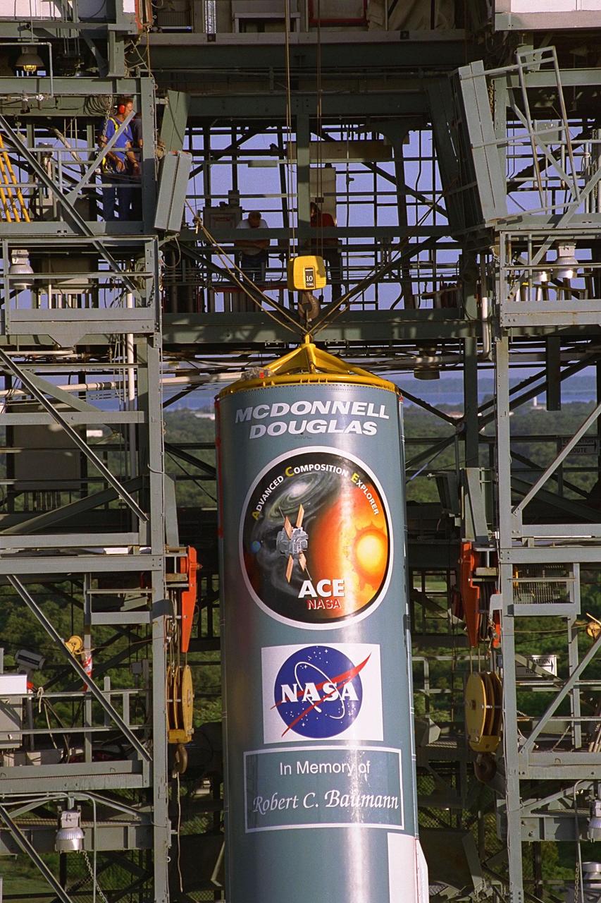 The first stage of the Delta II rocket which will to be used to launch the Advanced Composition Explorer (ACE) spacecraft is erected at Launch Complex 17A at Cape Canaveral Air Station. Scheduled for launch on Aug. 25, ACE will study low-energy particles of solar origin and high-energy galactic particles. The ACE observatory will be placed into an orbit almost a million miles (1.5 million kilometers) away from the Earth, about 1/100 the distance from the Earth to the Sun