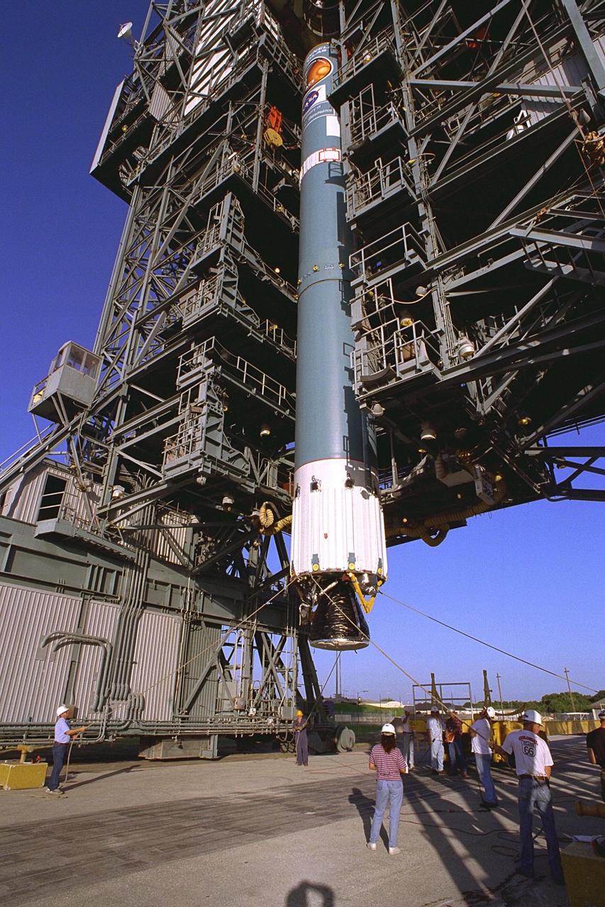 The first stage of the Delta II rocket which will to be used to launch the Advanced Composition Explorer (ACE) spacecraft is erected at Launch Complex 17A at Cape Canaveral Air Station. Scheduled for launch on Aug. 25, ACE will study low-energy particles of solar origin and high-energy galactic particles. The ACE observatory will be placed into an orbit almost a million miles (1.5 million kilometers) away from the Earth, about 1/100 the distance from the Earth to the Sun