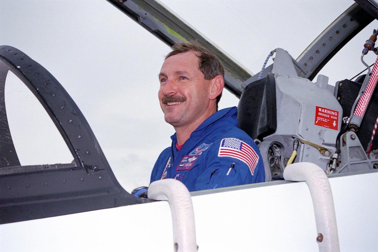 STS-85 Commander Curtis L. Brown, Jr. poses in the cockpit of his T-38 jet trainer aircraft at KSC’s Shuttle Landing Facility (SLF) after his arrival with the rest of the flight crew from NASA’s Johnson Space Center to begin final preparations for the STS-85 mission. The other crew members are Pilot Kent V. Rominger, Payload Commander N. Jan Davis, Mission Specialist Robert L. Curbeam, Jr., Mission Specialist Stephen K. Robinson and Payload Specialist Bjarni V. Tryggvason. The primary payload aboard the Space Shuttle orbiter Discovery for the 11-day space flight is the Cryogenic Infrared Spectrometers and Telescopes for the Atmosphere-2 (CRISTA-SPAS-2). Other STS-85 payloads include the Manipulator Flight Demonstration (MFD), and Technology Applications and Science-1 (TAS-1) and International Extreme Ultraviolet Hitchhiker-2 (IEH-2) experiments