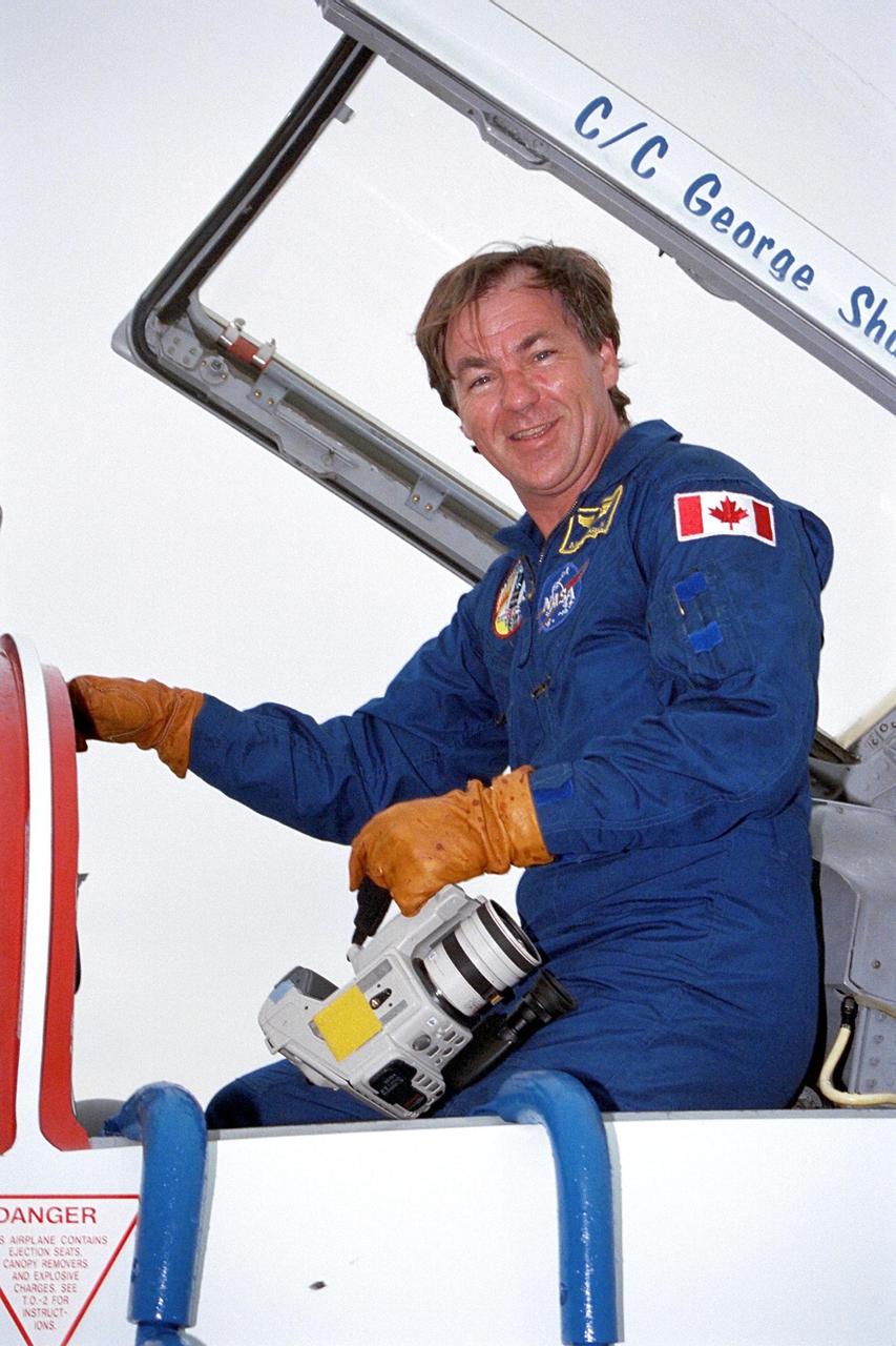 STS-85 Payload Specialist Bjarni V. Tryggvason poses in the cockpit of his T-38 jet trainer aircraft at KSC’s Shuttle Landing Facility (SLF) after his arrival with the rest of the flight crew from NASA’s Johnson Space Center to begin final preparations for the STS-85 mission. The other crew members are Commander Curtis L. Brown, Jr., Pilot Kent V. Rominger, Payload Commander N. Jan Davis, Mission Specialist Robert L. Curbeam, Jr., and Mission Specialist Stephen K. Robinson. The primary payload aboard the Space Shuttle orbiter Discovery for the 11-day space flight is the Cryogenic Infrared Spectrometers and Telescopes for the Atmosphere-2 (CRISTA-SPAS-2). Other STS-85 payloads include the Manipulator Flight Demonstration (MFD), and Technology Applications and Science-1 (TAS-1) and International Extreme Ultraviolet Hitchhiker-2 (IEH-2) experiments