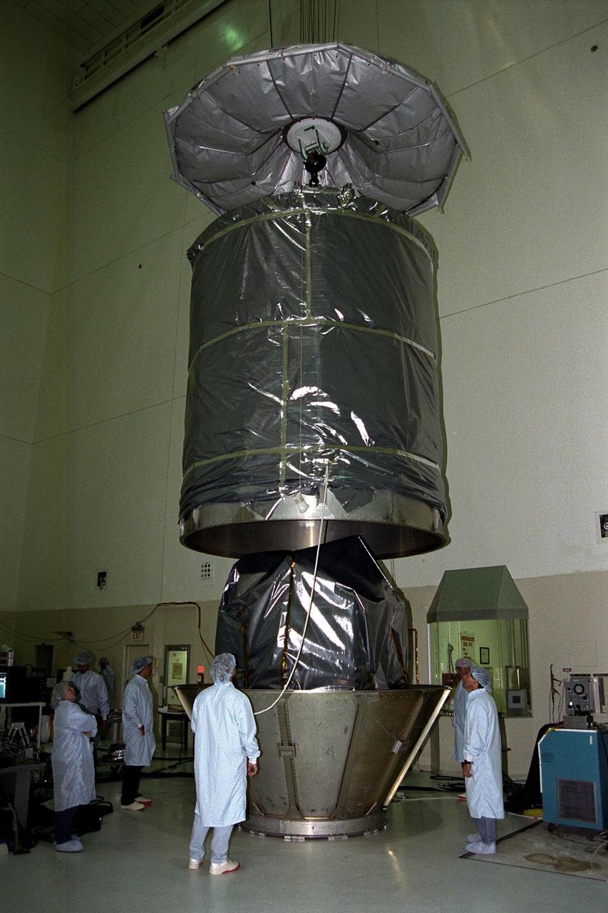 In KSC’s Spacecraft Assembly and Encapsulation Facility-II (SAEF-II), the Advanced Composition Explorer (ACE) spacecraft is encapsulated and placed into the transporter which will move it to Launch Complex 17A. Scheduled for launch on a Delta II rocket from Cape Canaveral Air Station on Aug. 24, ACE will study low-energy particles of solar origin and high-energy galactic particles. The collecting power of instruments aboard ACE is 10 to 1,000 times greater than anything previously flown to collect similar data by NASA