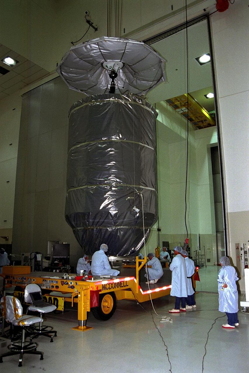 In KSC’s Spacecraft Assembly and Encapsulation Facility-II (SAEF-II), the Advanced Composition Explorer (ACE) spacecraft is encapsulated and placed into the transporter which will move it to Launch Complex 17A. Scheduled for launch on a Delta II rocket from Cape Canaveral Air Station on Aug. 24, ACE will study low-energy particles of solar origin and high-energy galactic particles. The collecting power of instruments aboard ACE is 10 to 1,000 times greater than anything previously flown to collect similar data by NASA