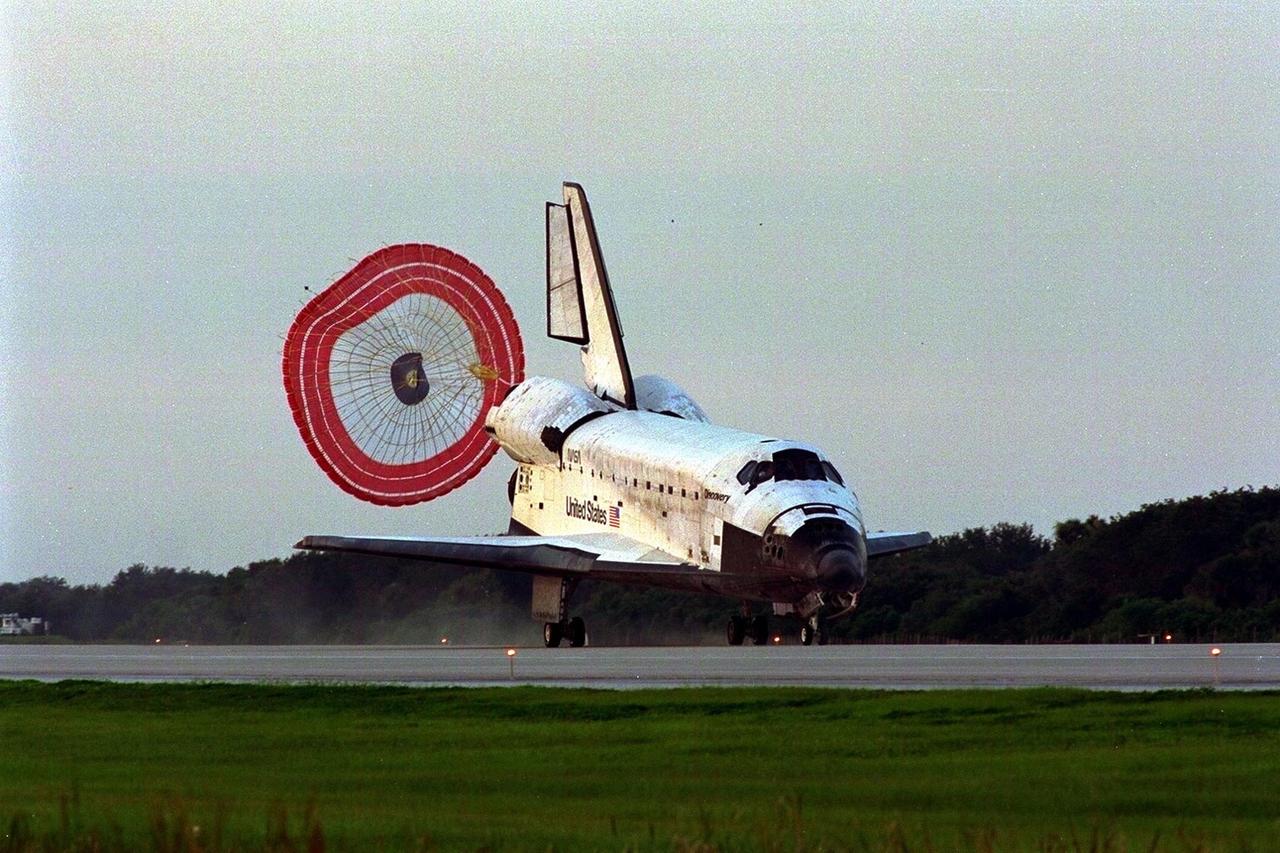 KENNEDY SPACE CENTER, FLA. -- With drag chute deployed, the Space Shuttle orbiter Discovery touches down on Runway 33 at KSC’s Shuttle Landing Facility at 7:07:59 a.m. EDT Aug. 19 to complete the 11-day, 20-hour and 27-minute-long STS-85 mission. At the controls are Commander Curtis L. Brown, Jr. and Pilot Kent V. Rominger. The first landing opportunity on Aug. 18 was waved off due to the potential for ground fog. Also onboard the orbiter are Payload Commander N. Jan Davis, Mission Specialist Robert L. Curbeam, Jr., Mission Specialist Stephen K. Robinson and Payload Specialist Bjarni V. Tryggvason. During the 86th Space Shuttle mission, the crew deployed the Cryogenic Infrared Spectrometers and Telescopes for the AtmosphereShuttle Pallet Satellite-2 (CRISTA-SPAS-2) free-flyer to conduct research on the Earth’s middle atmosphere, retrieving it on flight day 9. The crew also conducted investigations with the Manipulator Flight Demonstration (MFD), Technology Applications and Science-1 (TAS-1) and International Extreme Ultraviolet Hitchhiker-2 (IEH-2) experiments. Robinson also made observations of the comet Hale-Bopp with the Southwest Ultraviolet Imaging System (SWIS) while other members of the crew conducted biological experiments in the orbiter’s crew cabin. This was the 39th landing at KSC in the history of the Space Shuttle program and the 11th touchdown for Discovery at the space center