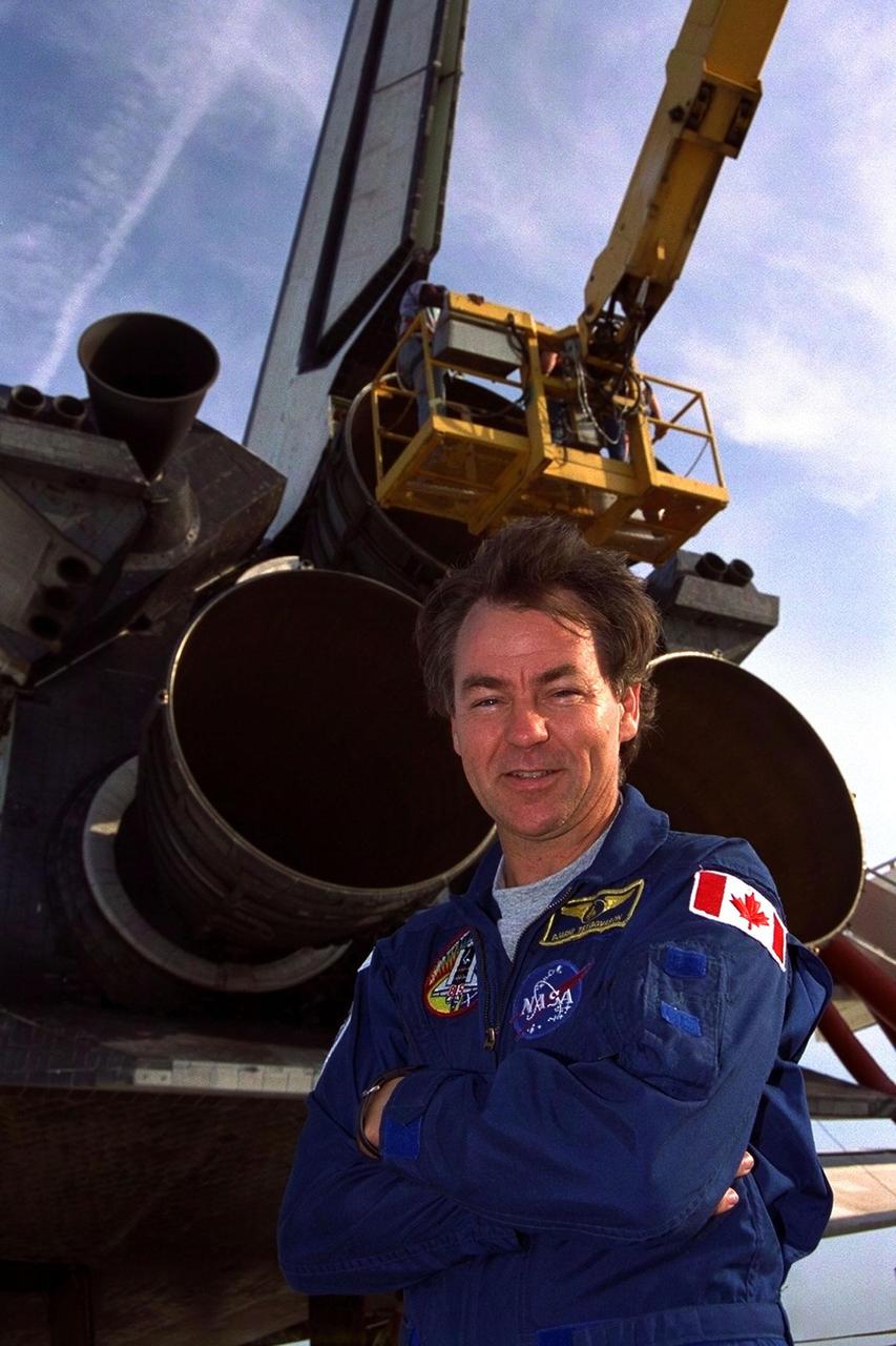 KENNEDY SPACE CENTER, FLA. -- STS-85 Payload Specialist and Canadian Space Agency astronaut Bjarni V. Tryggvason poses under the Space Shuttle orbiter Discovery after the space plane landed on Runway 33 at KSC’s Shuttle Landing Facility Aug. 19 to complete the 11-day, 20-hour and 27-minute-long STS-85 mission. Also on board were Commander Curtis L. Brown, Jr., Pilot Kent V. Rominger, Payload Commander N. Jan Davis, Mission Specialist Robert L. Curbeam, Jr. and Mission Specialist Stephen K. Robinson During the 86th Space Shuttle mission, the crew deployed the Cryogenic Infrared Spectrometers and Telescopes for the Atmosphere-Shuttle Pallet Satellite-2 (CRISTA-SPAS-2) free-flyer to conduct research on the Earth’s middle atmosphere, retrieving it on flight day 9. The crew also conducted investigations with the Manipulator Flight Demonstration (MFD), Technology Applications and Science-1 (TAS-1) and International Extreme Ultraviolet Hitchhiker-2 (IEH-2) experiments. This was the 39th landing at KSC in the history of the Space Shuttle program and the 11th touchdown for Discovery at the space center