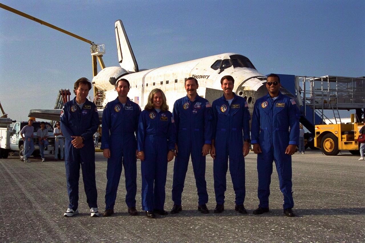 KENNEDY SPACE CENTER, FLA. -- The STS-85 crew poses in front of the Space Shuttle orbiter Discovery after the space plane landed on Runway 33 at KSC’s Shuttle Landing Facility Aug. 19 to complete the 11-day, 20-hour and 27-minute-long STS-85 mission. They are (from left): Payload Specialist and Canadian Space Agency astronaut Bjarni V. Tryggvason; Mission Specialist Stephen K. Robinson; Payload Commander N. Jan Davis; Commander Curtis L. Brown, Jr.; Pilot Kent V. Rominger, and Mission Specialist Robert L. Curbeam, Jr. During the 86th Space Shuttle mission, the crew deployed the Cryogenic Infrared Spectrometers and Telescopes for the AtmosphereShuttle Pallet Satellite-2 (CRISTA-SPAS-2) free-flyer to conduct research on the Earth’s middle atmosphere, retrieving it on flight day 9. The crew also conducted investigations with the Manipulator Flight Demonstration (MFD), Technology Applications and Science-1 (TAS-1) and International Extreme Ultraviolet Hitchhiker-2 (IEH-2) experiments. This was the 39th landing at KSC in the history of the Space Shuttle program and the 11th touchdown for Discovery at the space center