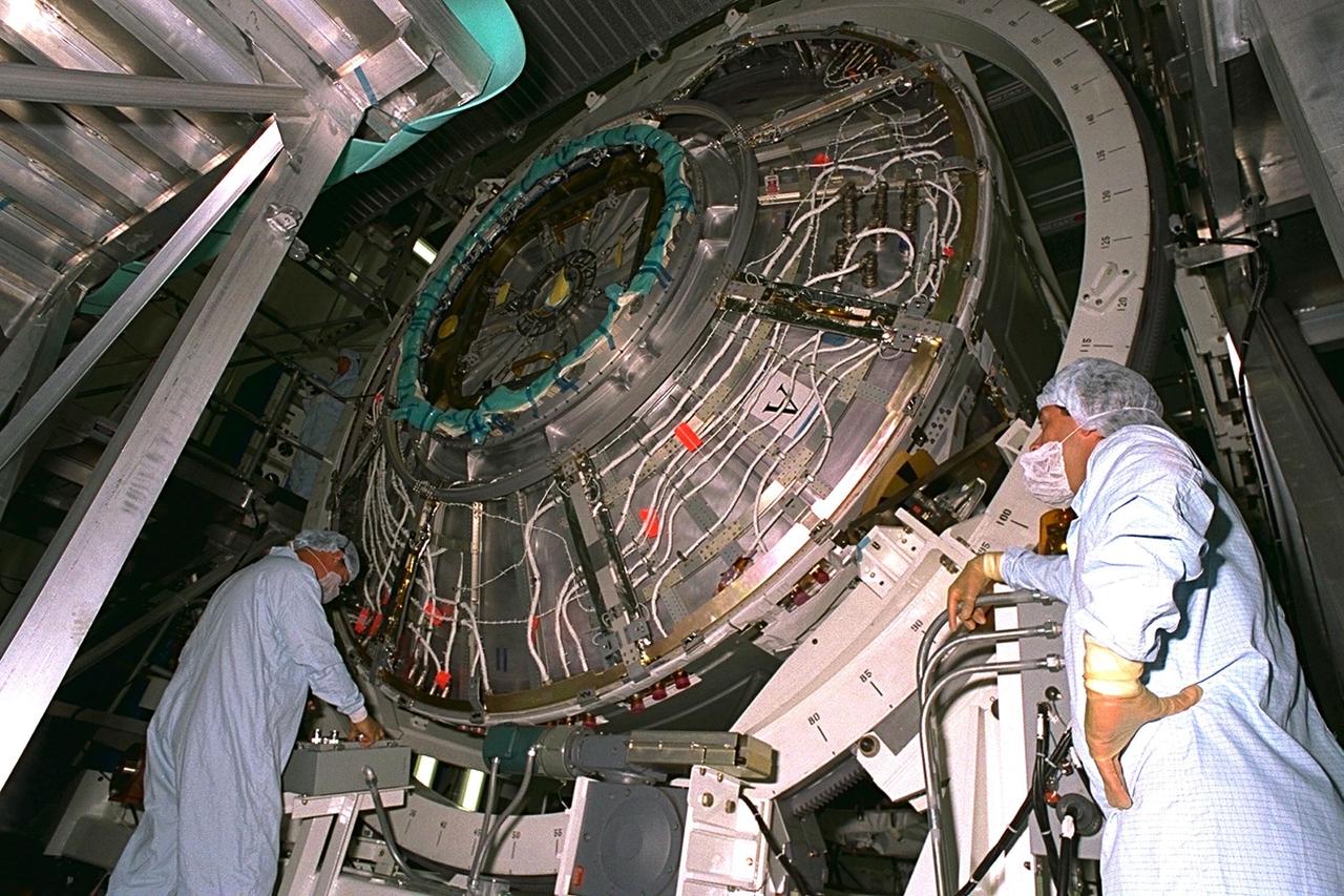 Workers rotate the Node 1, part of the primary payload of the first Space Shuttle launch of an International Space Station (ISS) element, during processing activities in the Space Station Processing Facility. Along with two Pressurized Mating Adapters, Node 1 is scheduled to be launched aboard the Space Shuttle Endeavour on Mission STS-88 in July 1998. The 22-foot-long module has a diameter of 18 feet. Node 1 will serve as a connecting passageway to the living and working areas of the ISS
