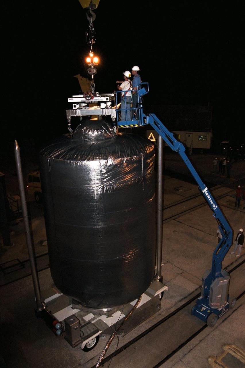 Technicians at Launch Complex 40, Cape Canaveral Air Station (CCAS), connect the crane to the top of the Cassini spacecraft in preparation for the lift to the top of its Titan IV/Centaur launch vehicle. Cassini is an international mission conducted by the National Aeronautics and Space Administration (NASA), the European Space Agency (ESA), and the Italian Space Agency (ASI). The two-story-tall spacecraft, scheduled for launch on Oct. 6, is destined to arrive at Saturn in July 2004, where it will orbit and study Saturn, its rings, moons and magnetic environment in detail over a four-year period. The Cassini mission is managed for NASA's Office of Space Science by the Jet Propulsion Laboratory, a division of the California Institute of Technology